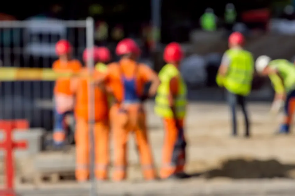 A group of construction workers standing next to each other.